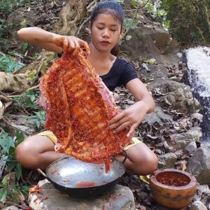 Pork ribs grilled spicy delicious for dinner near waterfall - Survival cooking in jungle
