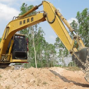 Caterpillar 312B Excavator Loading Mercedes And Man Trucks - Excavator In The Rice Field