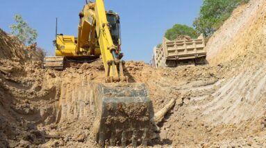 Komatsu PC 130 excavator loading in canal || Land trucks for making canal