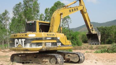 Land Trucks & Caterpillar 312B Excavator Loading In Rice Field - Farming Job
