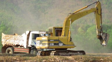 Caterpillar 311B Excavator Loading Mercedes And Man Trucks