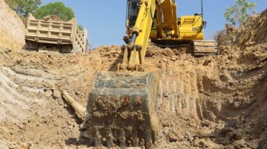 Power Tools: Komatsu PC 130 excavator loading in canal || Land trucks for making canal